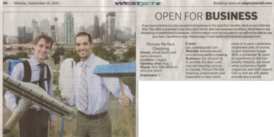 Founders Aaron Graham and Jared Sarbit holding cleaning equipment, featured in a 2010 Calgary Herald article introducing Picture Perfect Cleaning to Calgary.