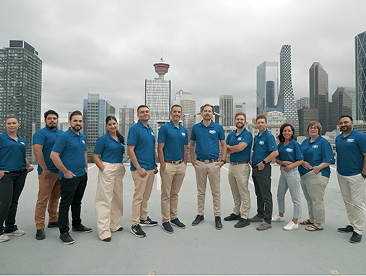 The Picture Perfect Cleaning leadership team standing together on a rooftop in downtown Calgary with the city skyline in the background.