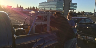Two Picture Perfect Cleaning team members load janitorial equipment into a truck at sunrise, marking the first day servicing Edmonton locations.
